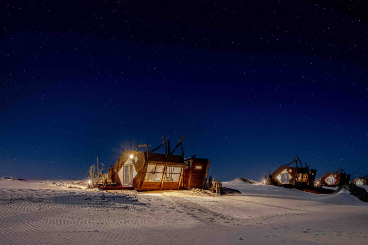 Africa, Namibia, Shipwreck Lodge Cabin on Skeleton Coast at night 