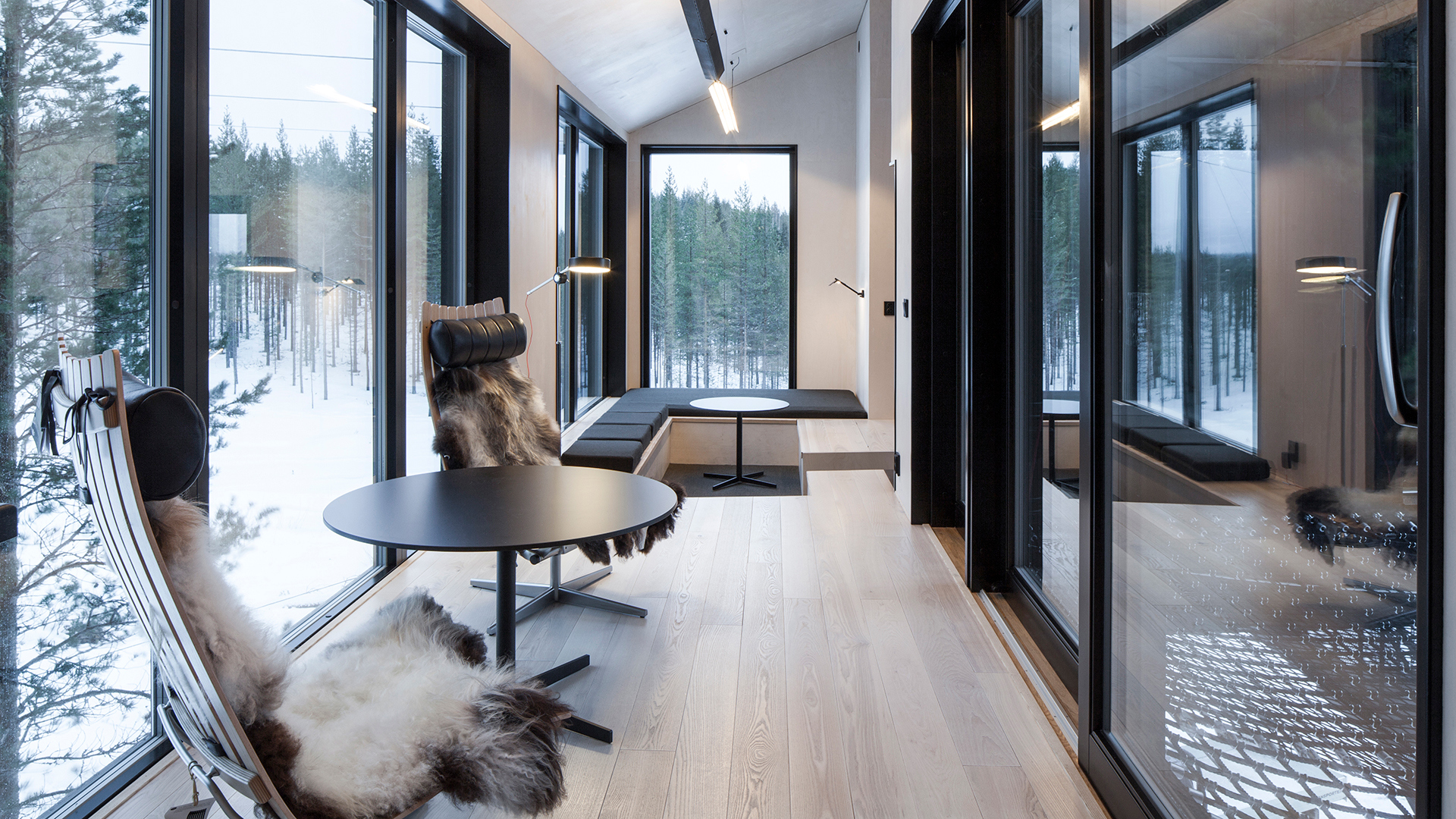 Two fur covered chairs in a room at Treehotel