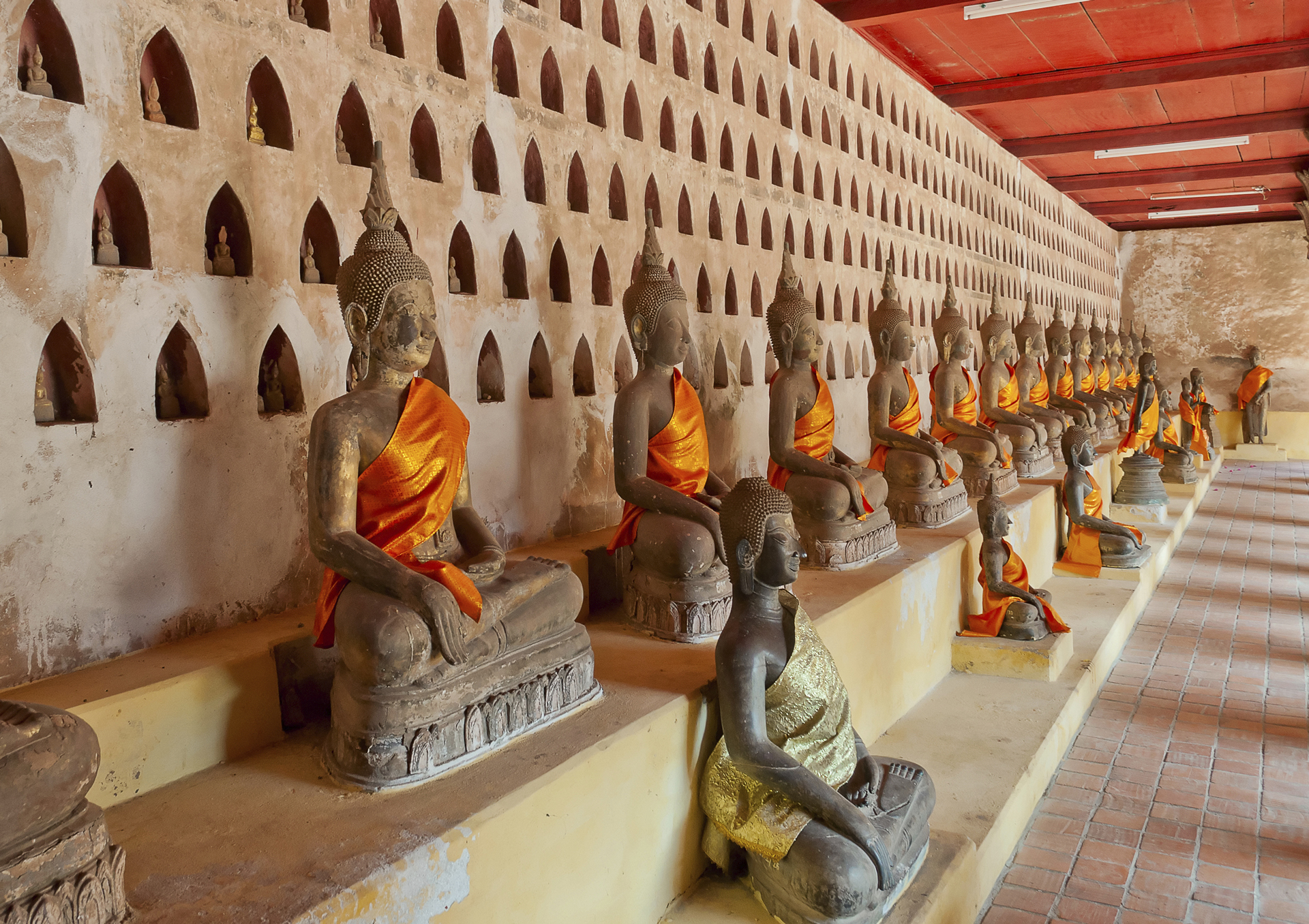 Buddha statues with golden robes in a row