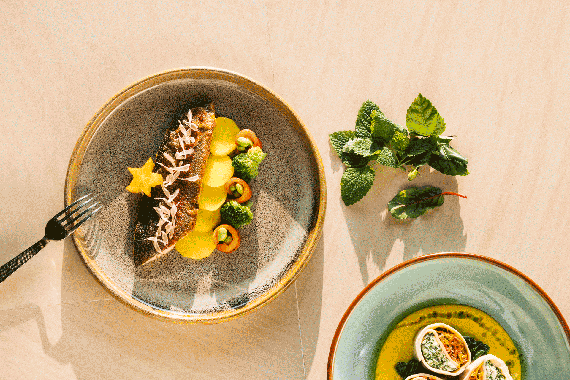 Vibrant, health-focused dish at Six Senses Vana featuring plated fish, vegetables, and fresh herbs.