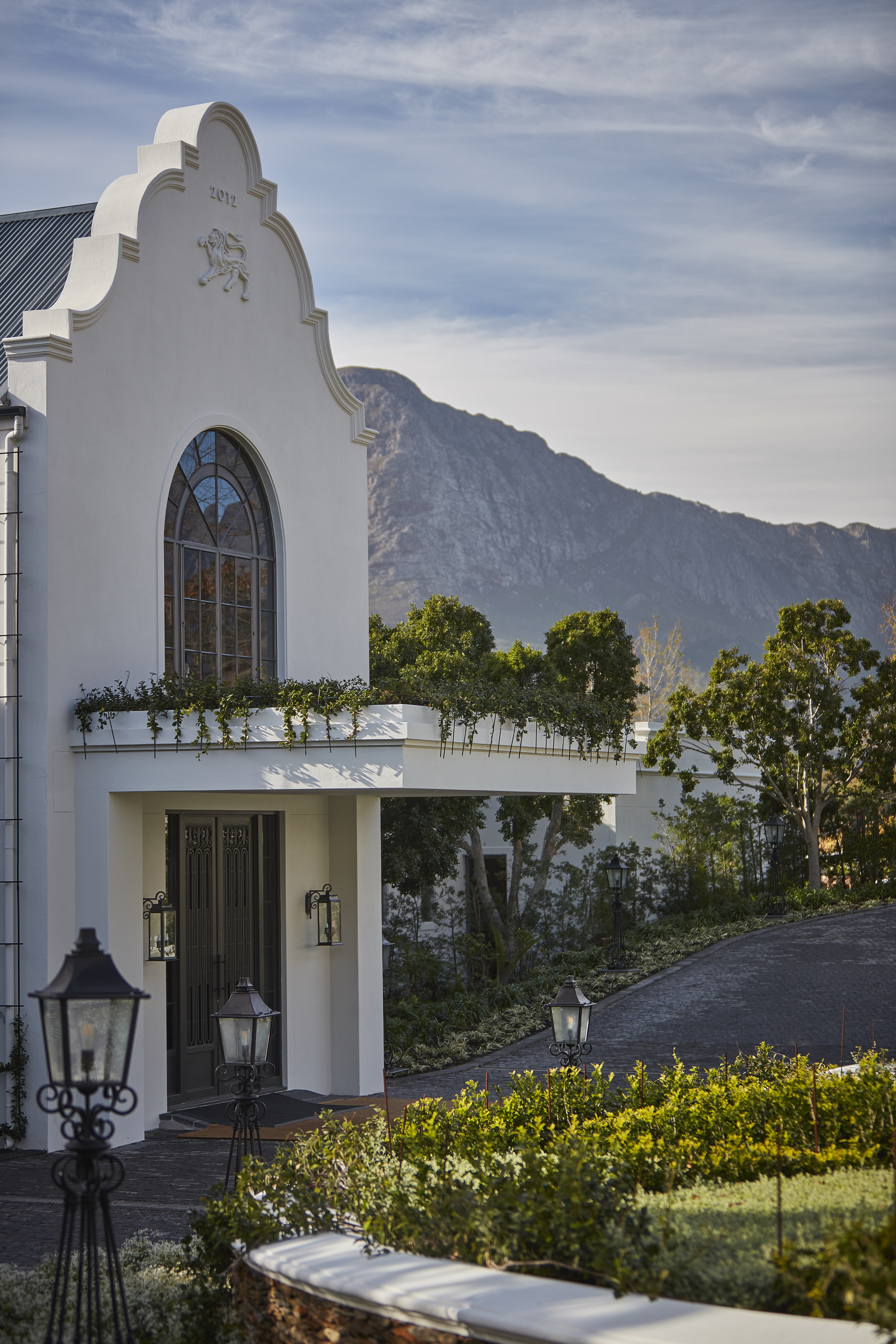 The main entrance of a white manor house