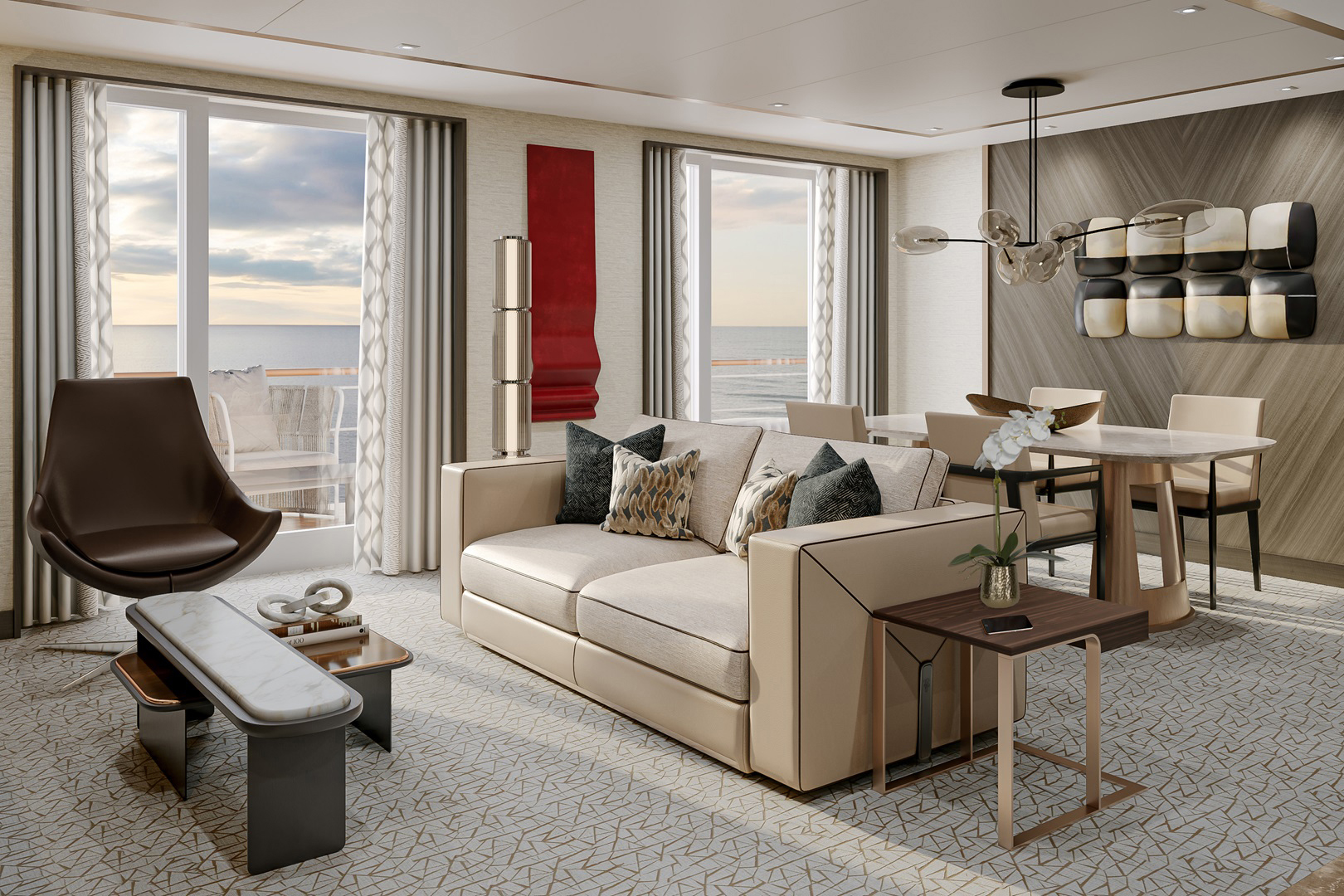 The large lounge of the Seven Seas Suite aboard Seven Seas Prestige featuring neutral modern furniture with red accents and sweeping views of the ocean