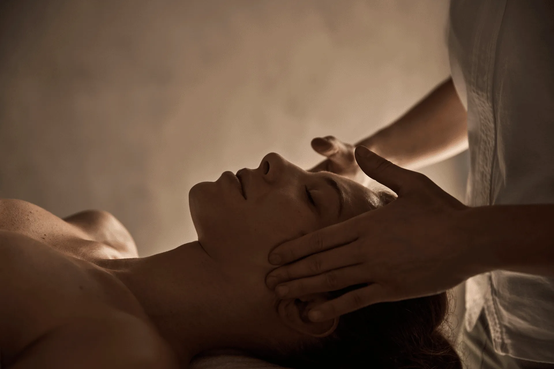 Close-up of a facial massage at COMO Alpina Dolomites with gentle hands applying soothing pressure.
