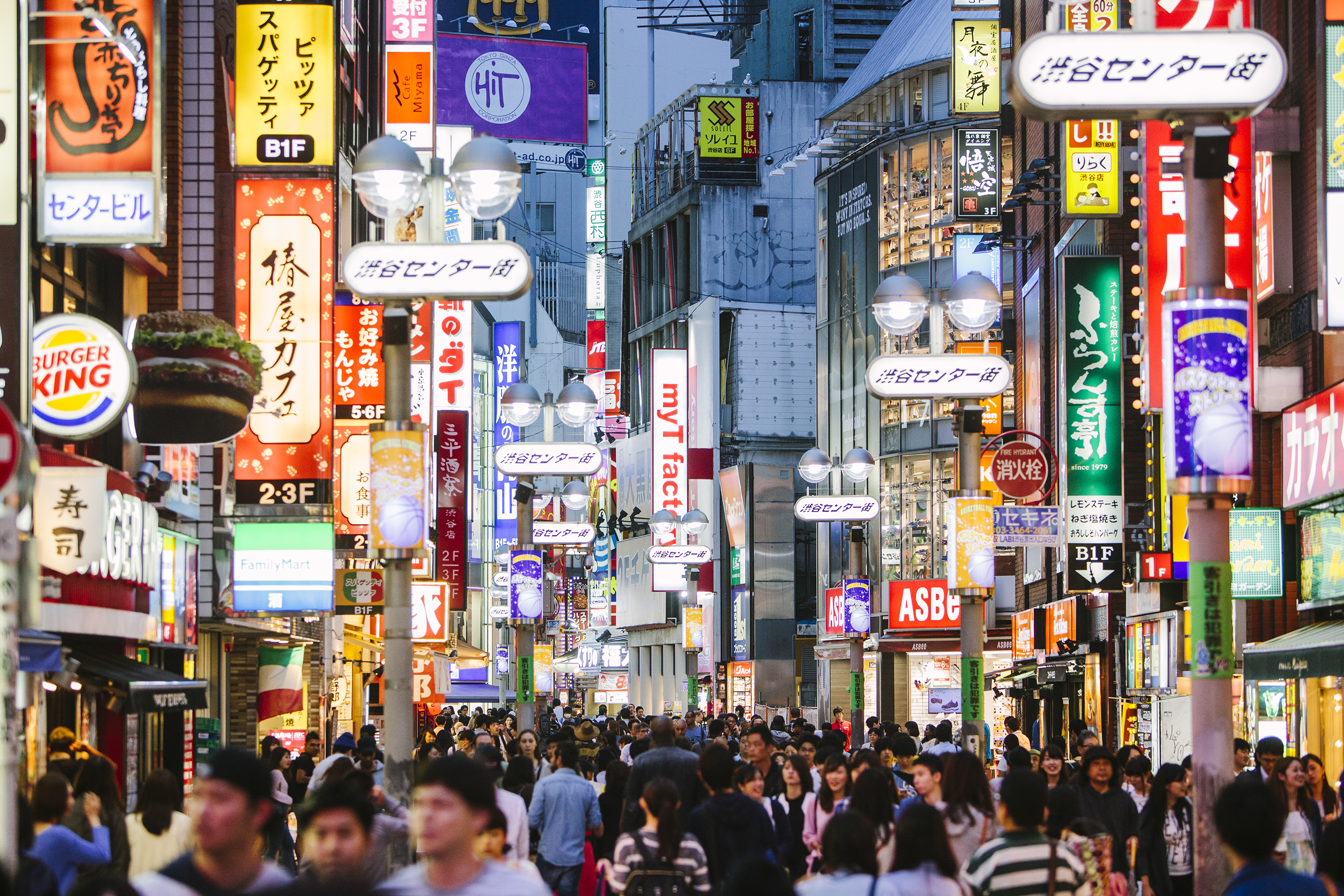A busy street full of neon signs in Tokyo