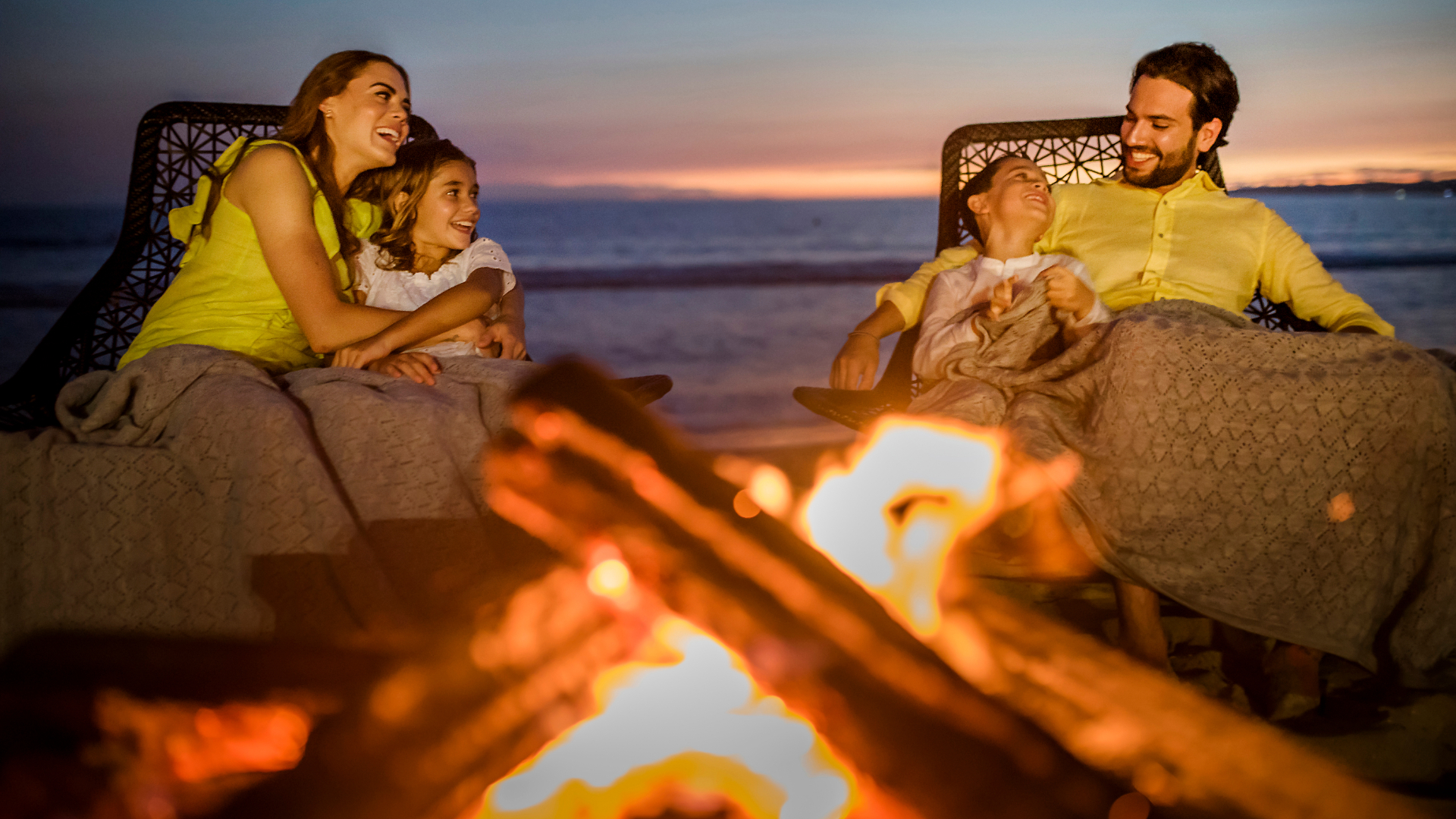 A family having a bonfire on a beach
