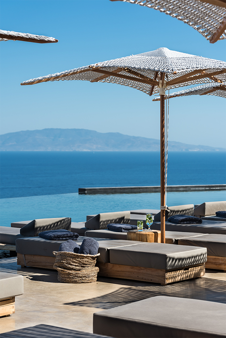 Sun loungers and a wooden parasol overlook the Mediterranean