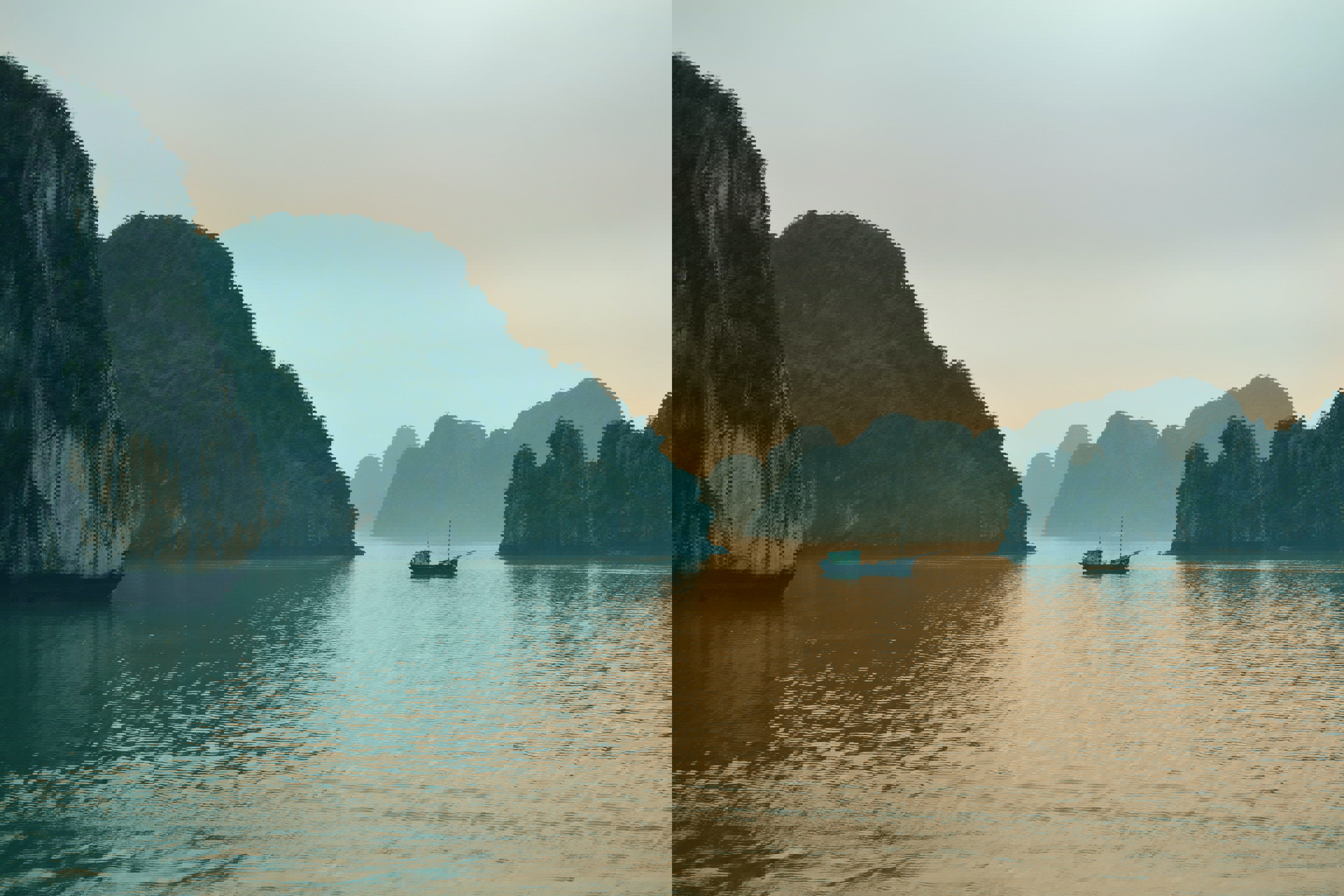 Traditional junk floating between limestone cliffs in Halong Bay