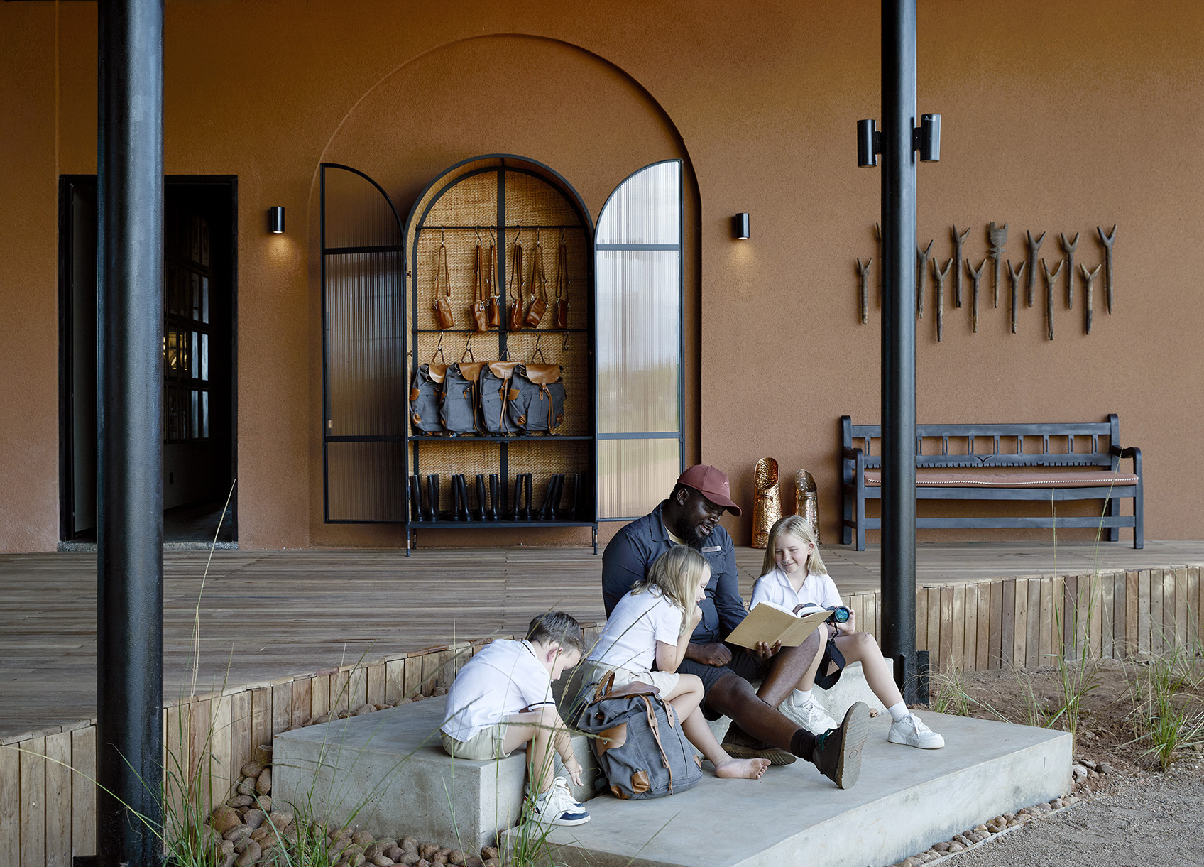 Afirca, Zambia, Chichele Presidential, guide reading to three young children 