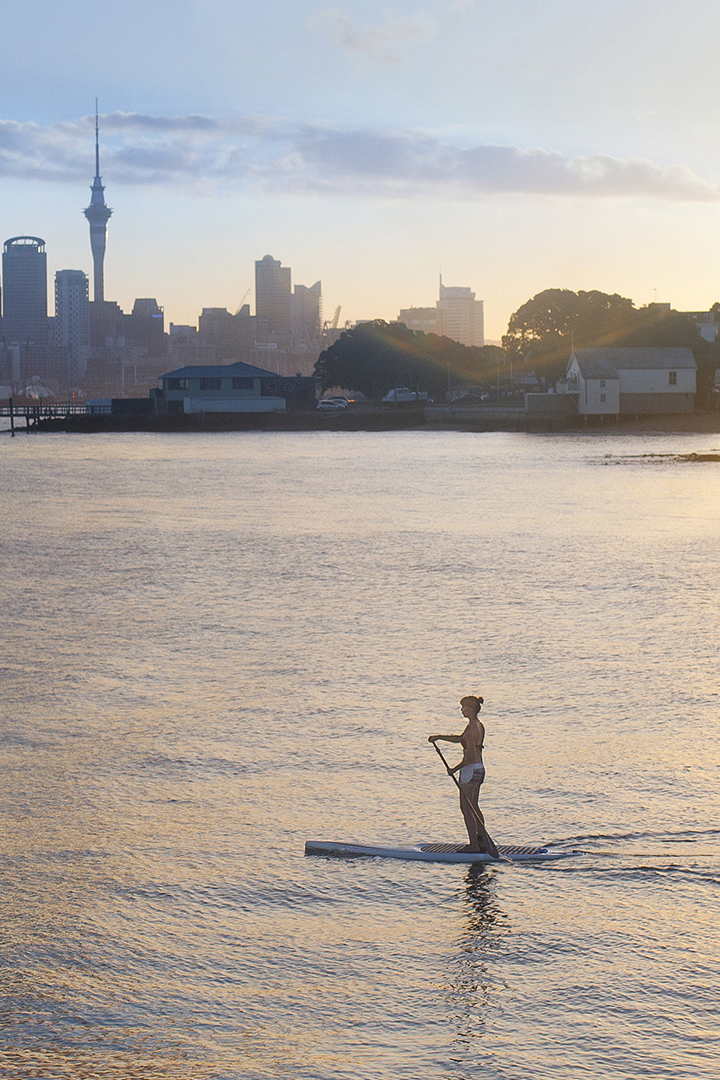 Woman paddleboarding in the ocean off Auckland