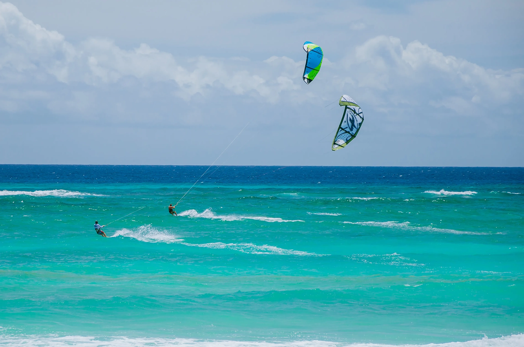 Two men kite surfing off the coast of barbados