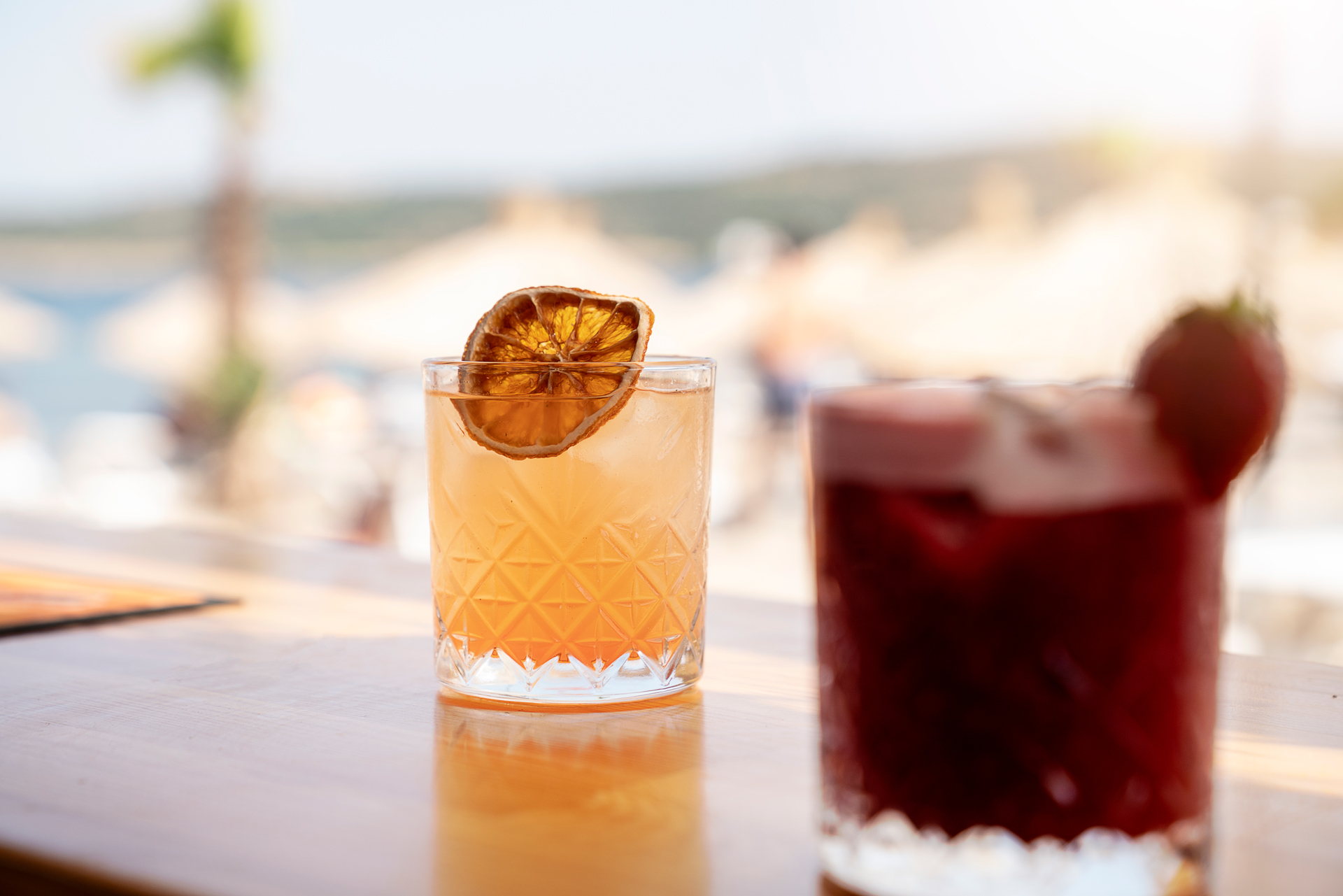 Fresh summer bohemian cocktail with ice and orange peel