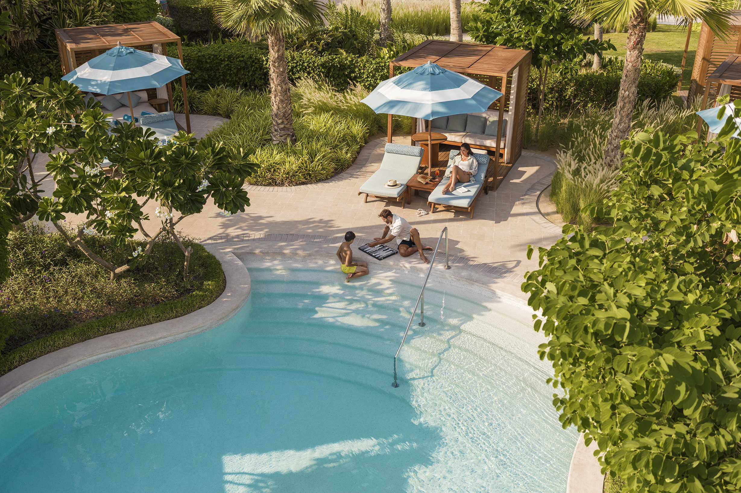 Family playing by the pool at Jumeirah Beach Hotel