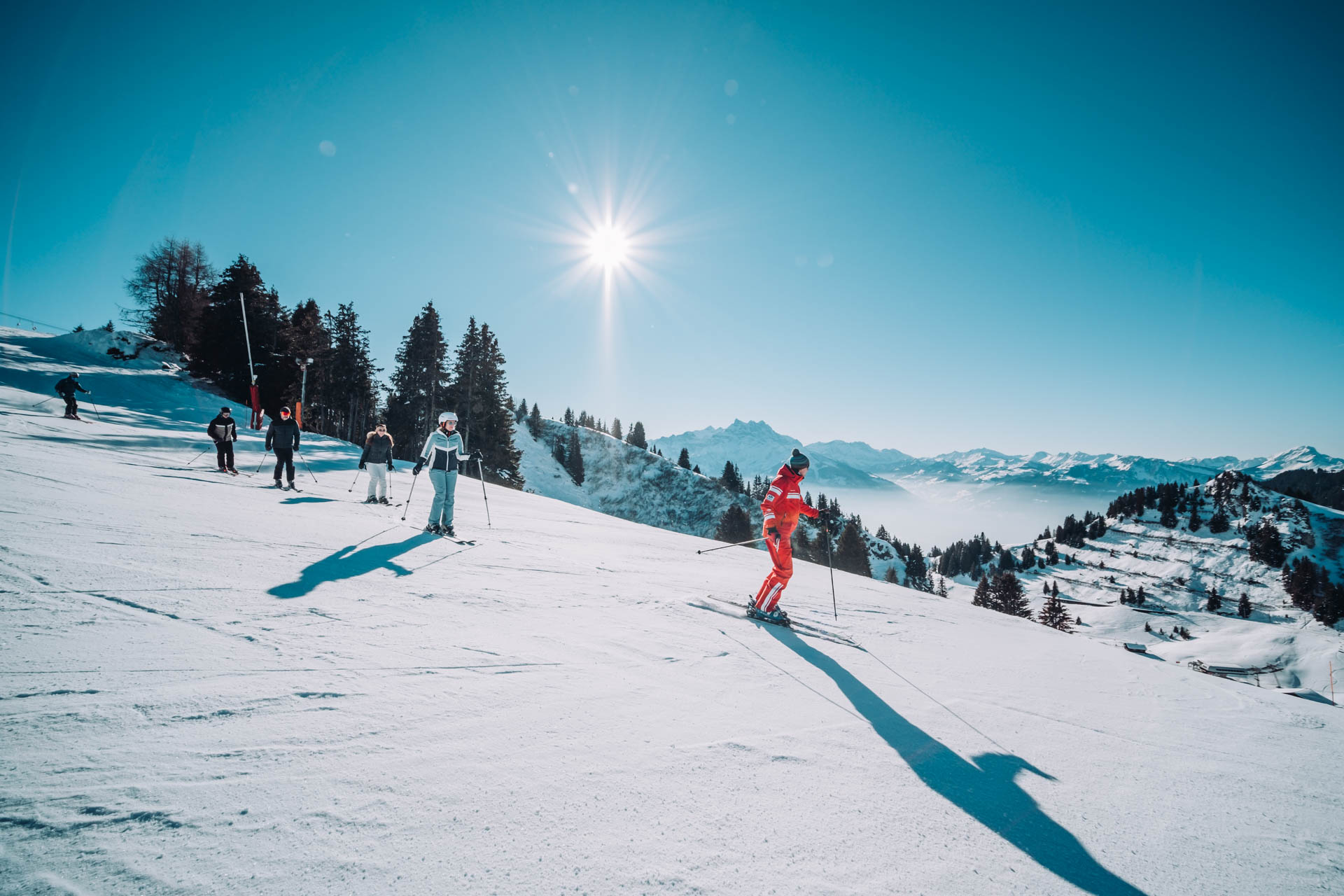 A group of skiers going down a slope