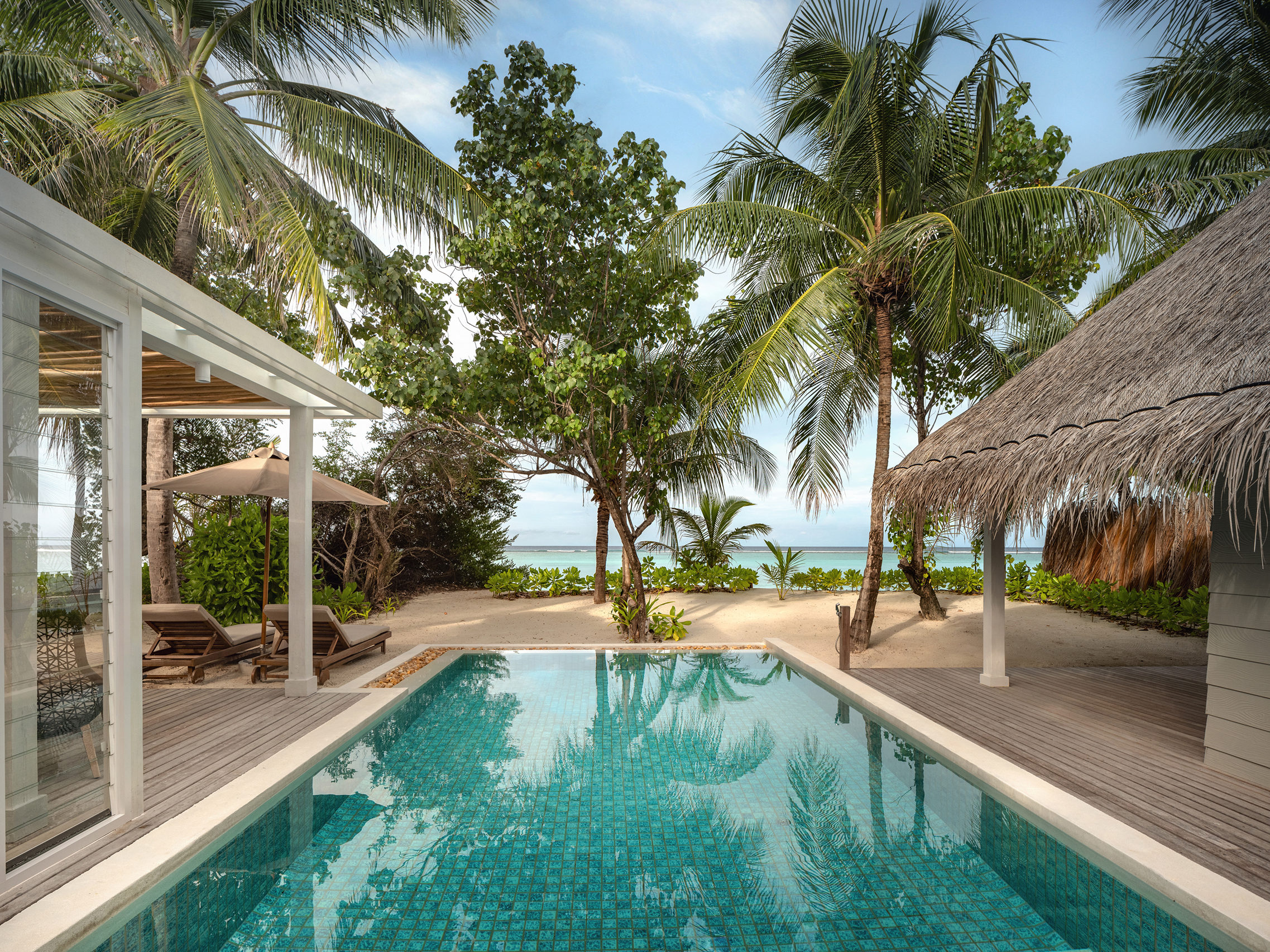 Pool looking out to the beach and sea in a deluxe beach villa suite at Six Senses Kanuhura