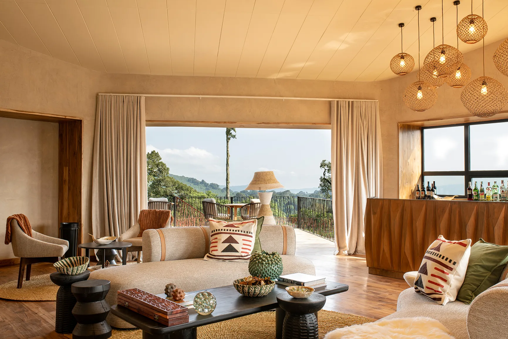 Elegant lodge lounge with terrace seating and panoramic forest views