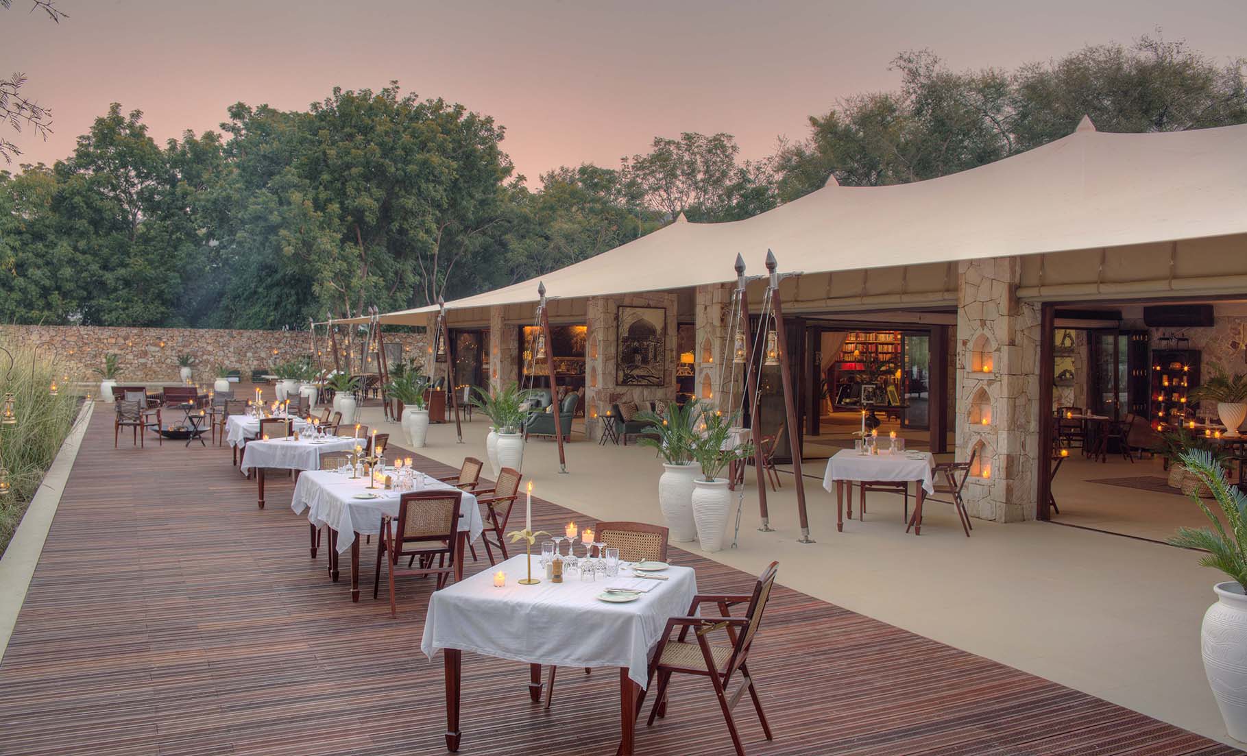 Asia, India, SUJAN Sher Bagh, outdoor dining tables lit by candlelight 