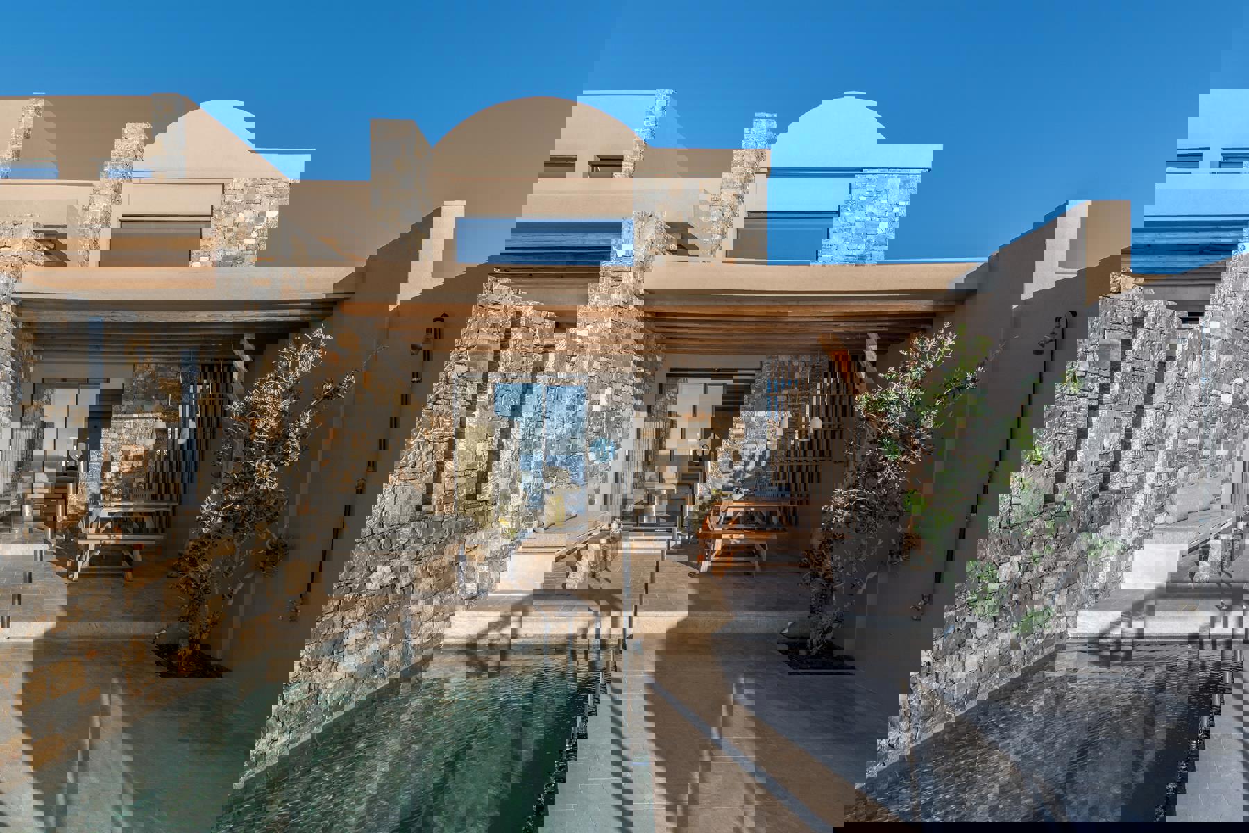 Suite pool terrace with olive tree and outdoor furniture 