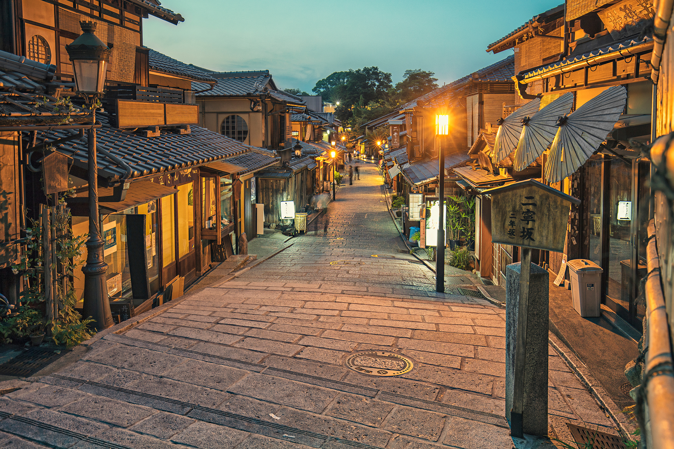 A quiet street in Gion in Kyoto lined with Edo period buildings at dusk