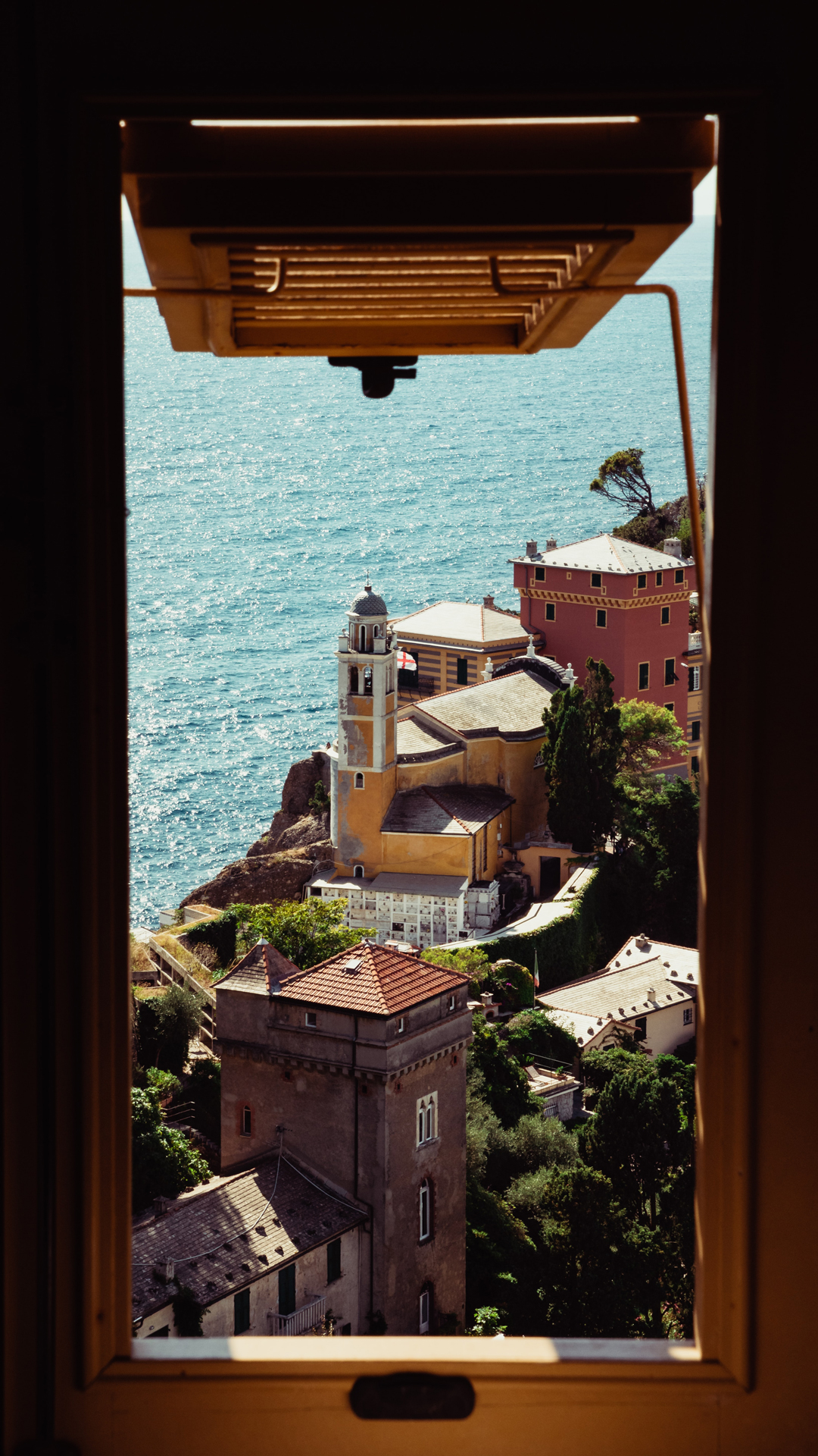 Looking out a window at buildings in the fishing village of Portofino