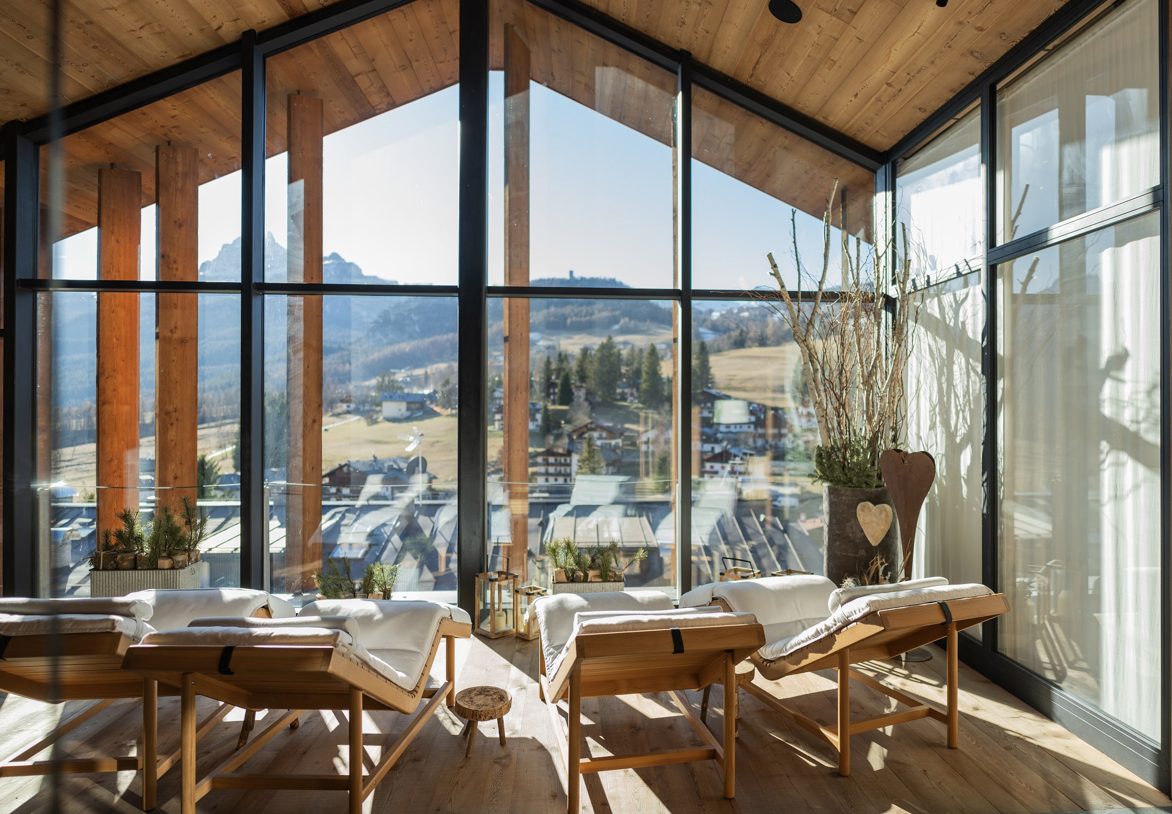 Sun loungers positioned in front of floor to veiling window looking out over the mountainous landscape