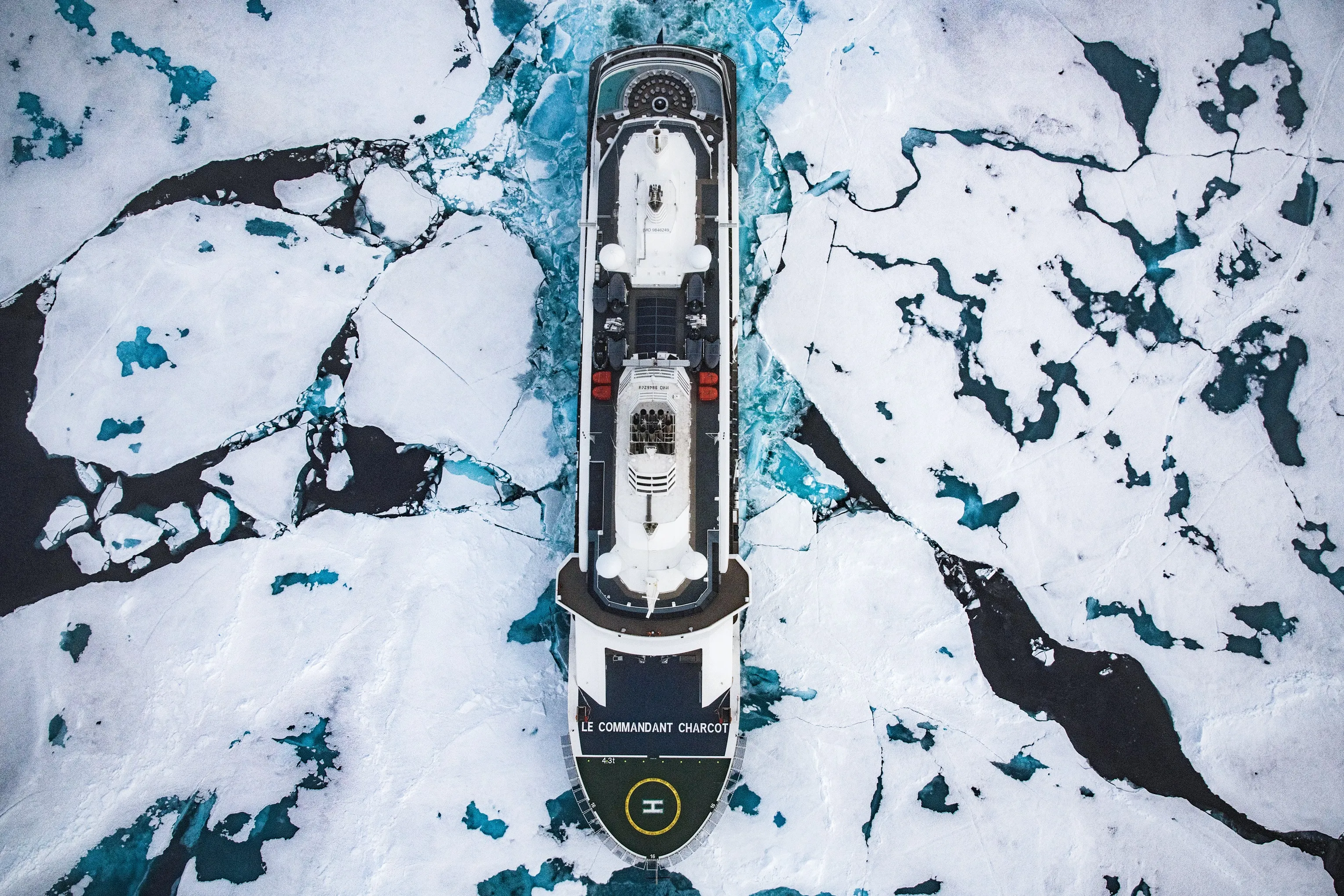 Aerial view of Ponant’s Le Commandant Charcot icebreaker navigating through a sea of drifting ice floes.