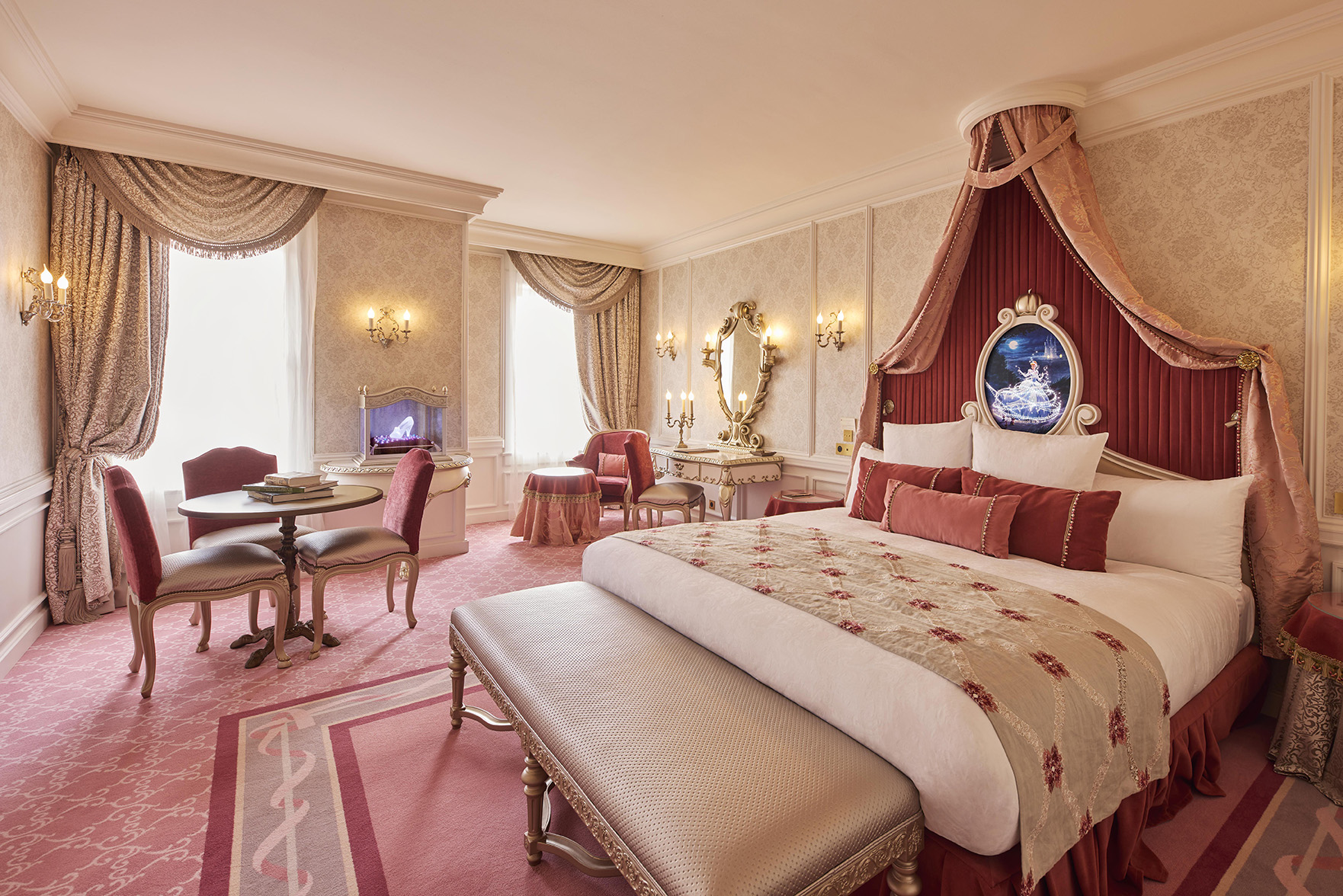 Europe, France, Paris, Disneyland® Hotel, the bedroom in the Cinderella Signature Suite, with a bed, dressing table, mirror and dinig table decorated in pink