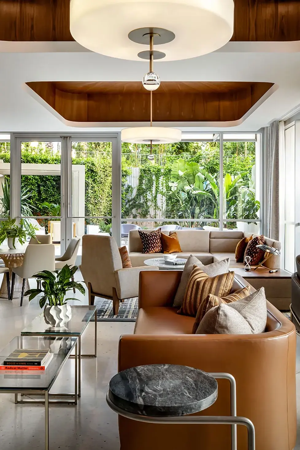 Elegant Fairmont Gold Lounge at Fairmont Century Plaza in Los Angeles featuring modern seating, warm décor, and lush garden views through floor‑to‑ceiling windows.