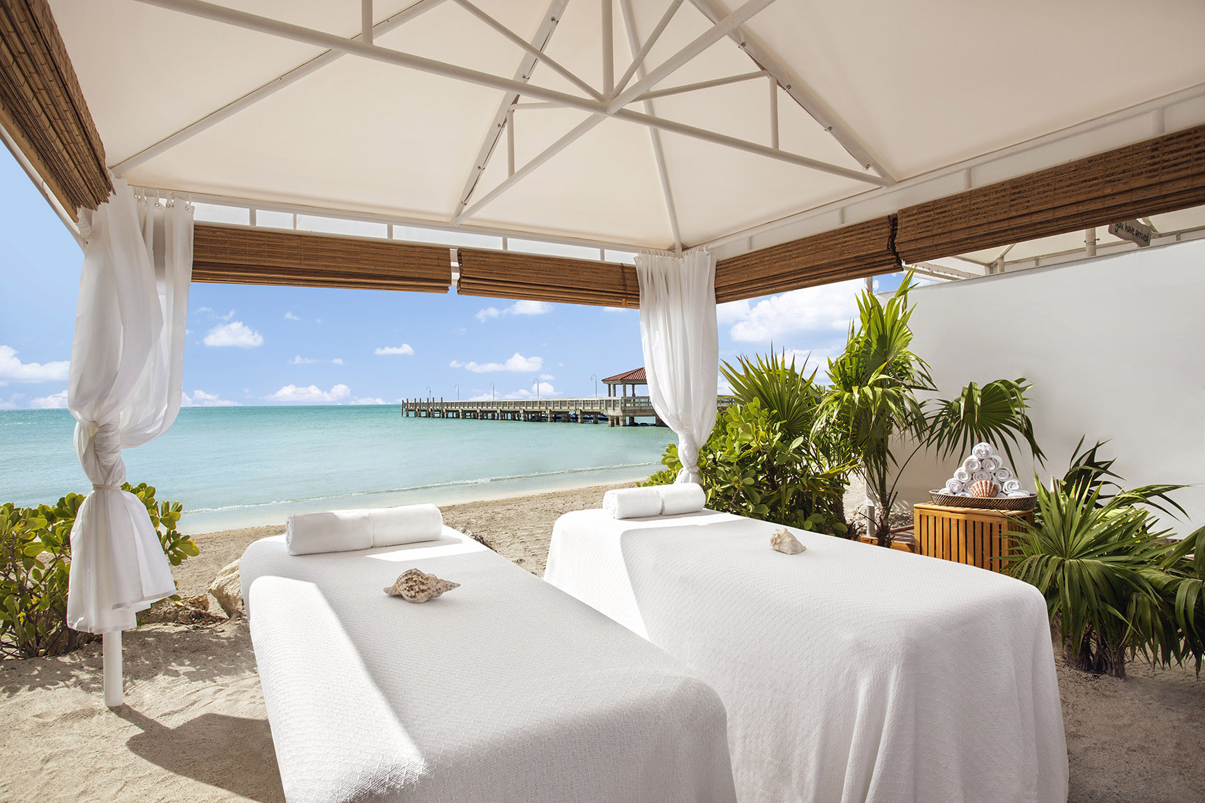 Two spa treatment beds facing the sea in an oceanfront spa tent at Casa Marina Key West, Florida