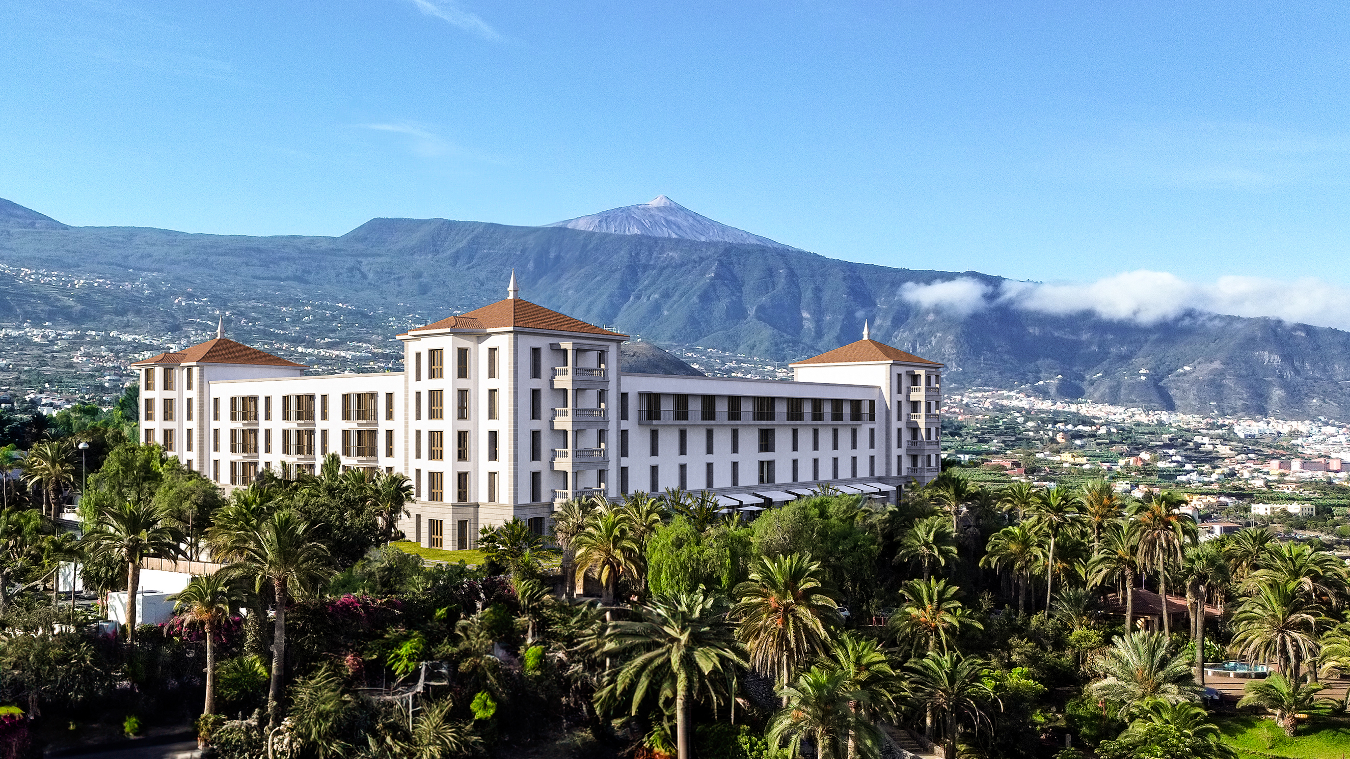 Grand Hotel Taoro surrounded by lush tropical gardens with Mount Teide in the background on a clear day.