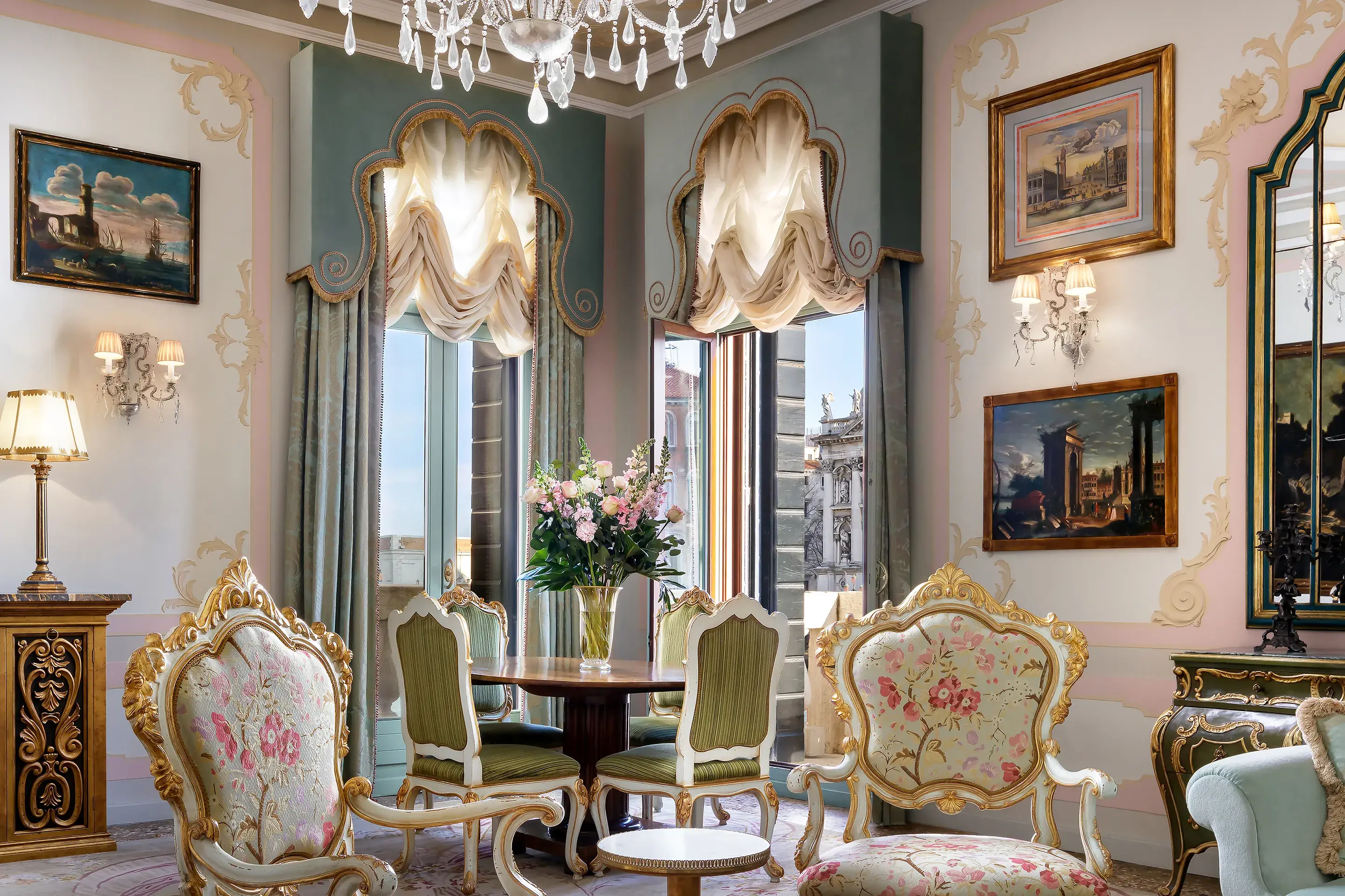 Opulent sitting room of a suite at The Gritti Palace in Venice with ornate furniture, chandeliers, and classic Venetian décor overlooking the Grand Canal.