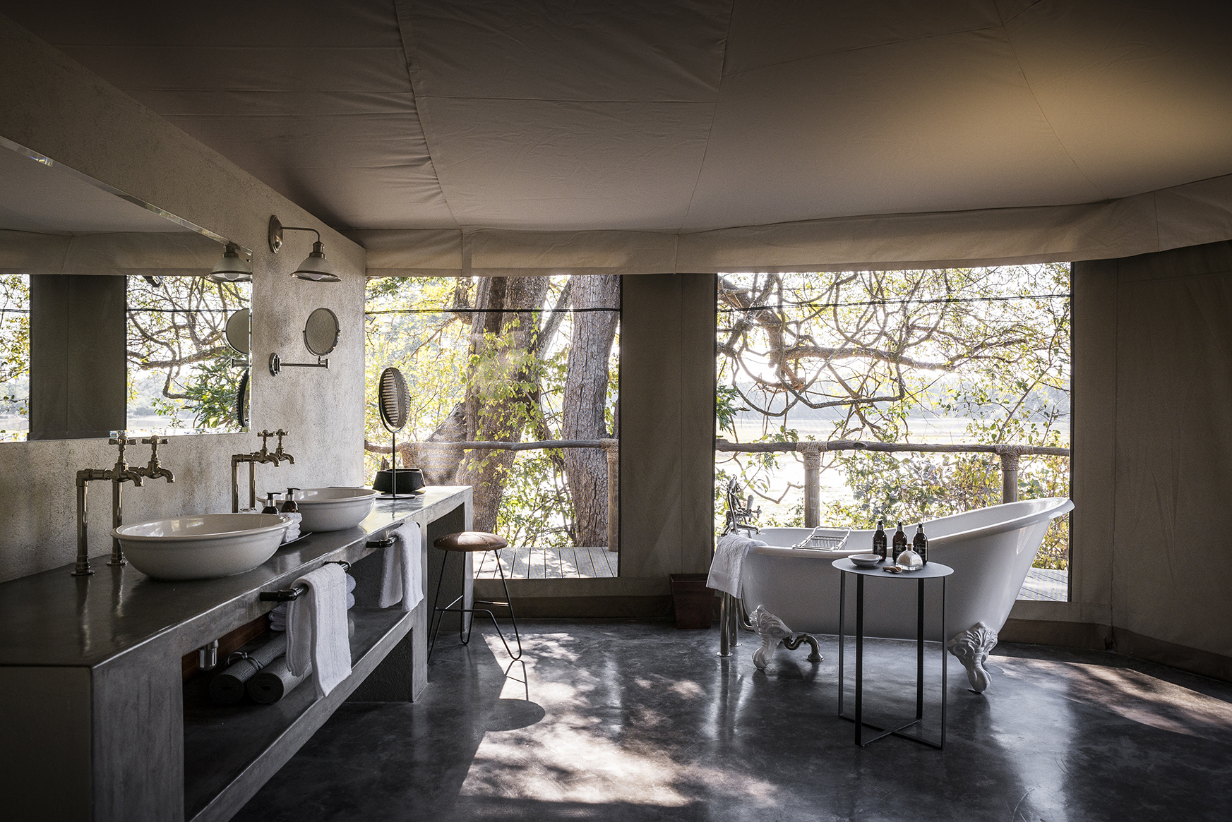 Africa, Zambia, Sungani Lodge, freestanding bathtub and sinks in a bathroom