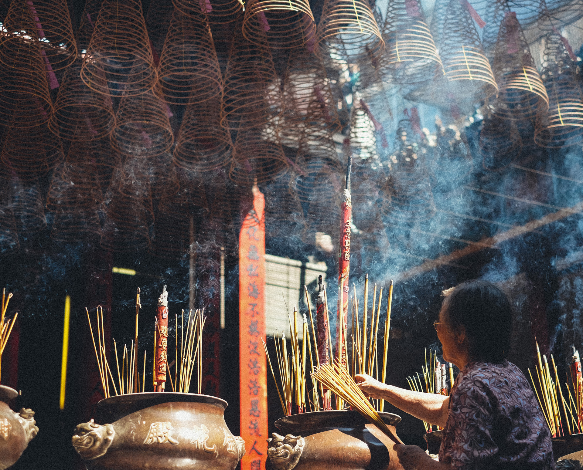 Lighting up giant sticks of incense at Thien Hau Pagoda in Saigon