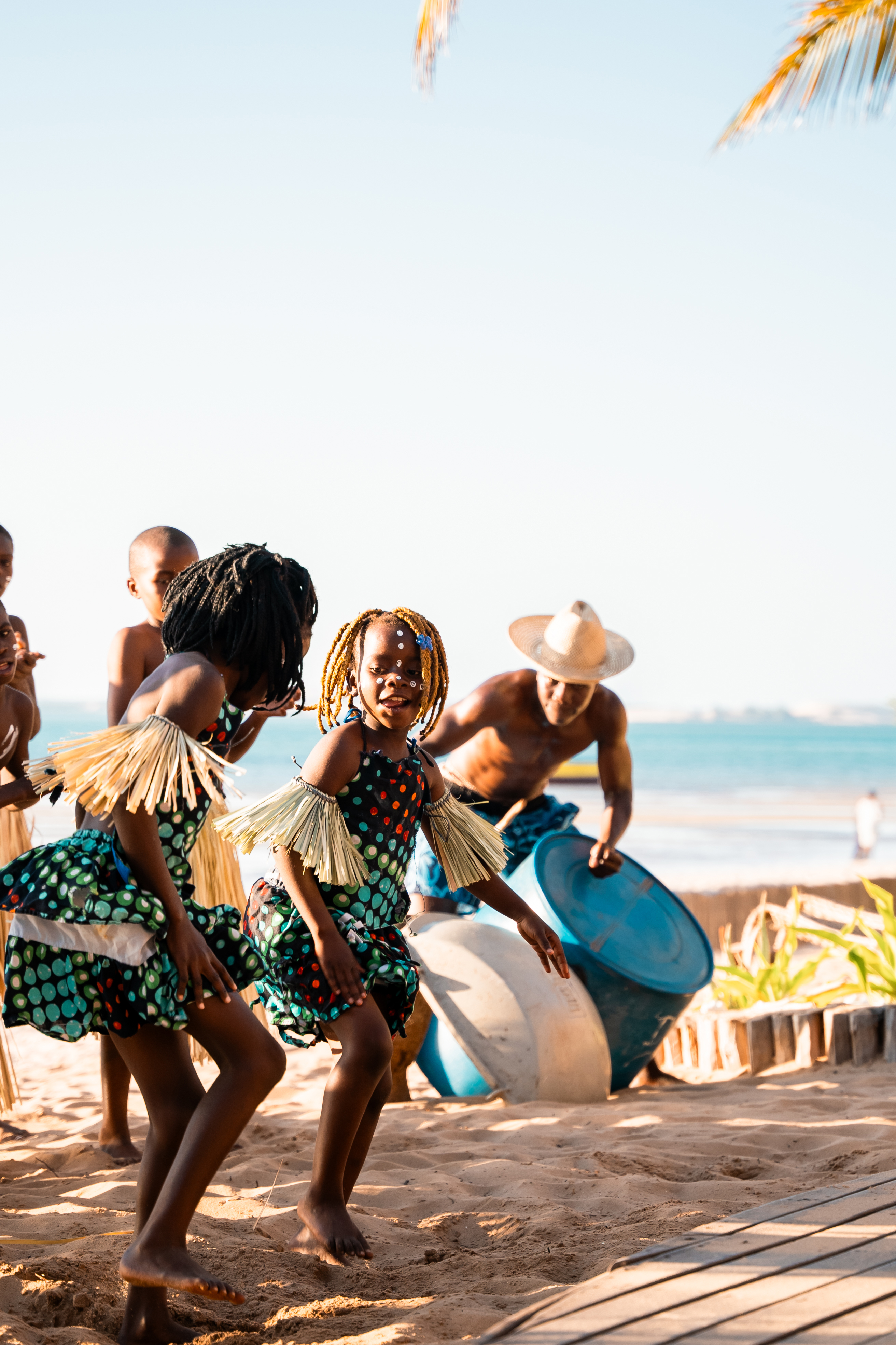 Locals in traditional dress dancing on the sand 