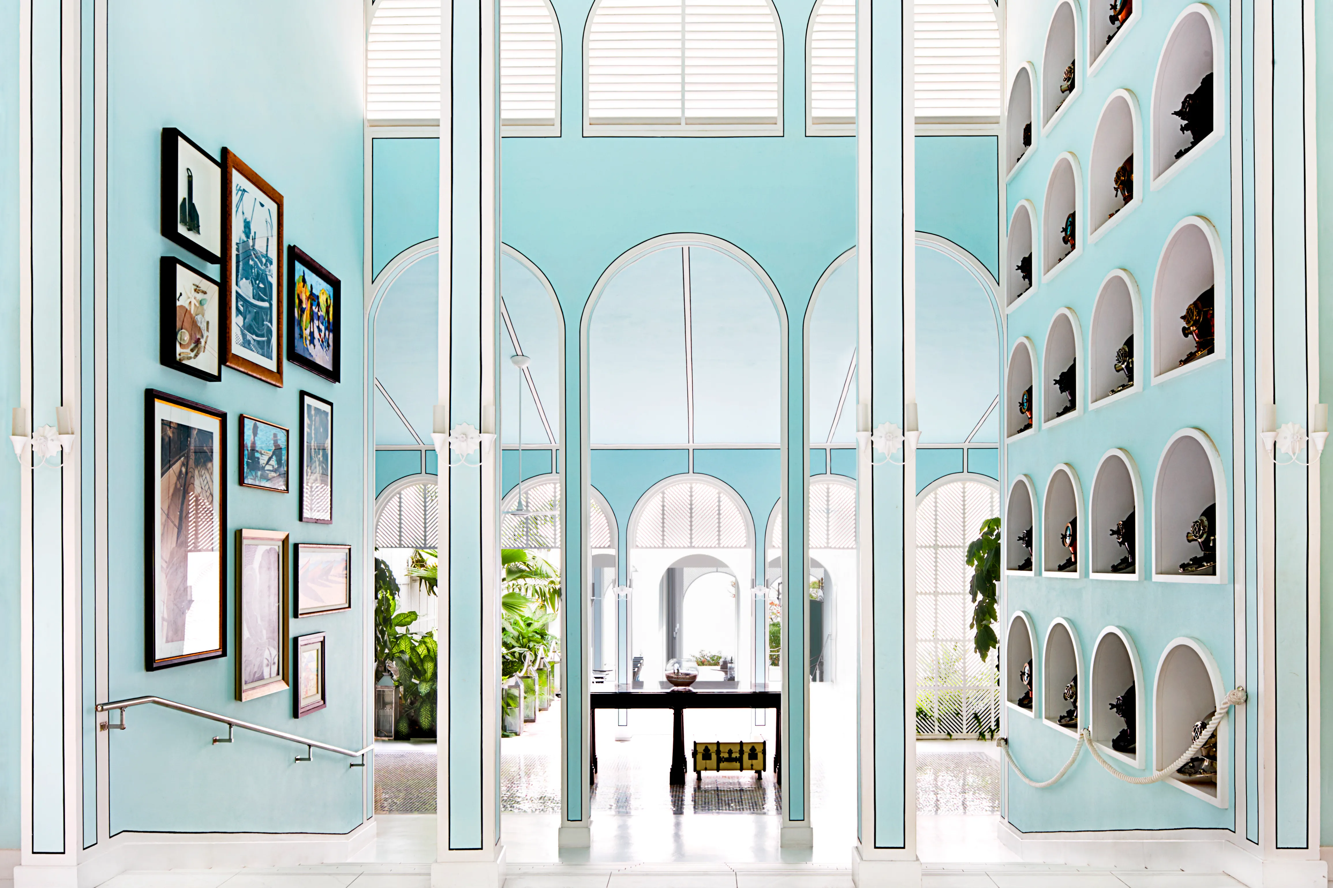 Grand entrance lobby at Malliouhana Resort, Anguilla, showcasing elegant Caribbean architecture, soaring archways, curated artwork, and luxury island design