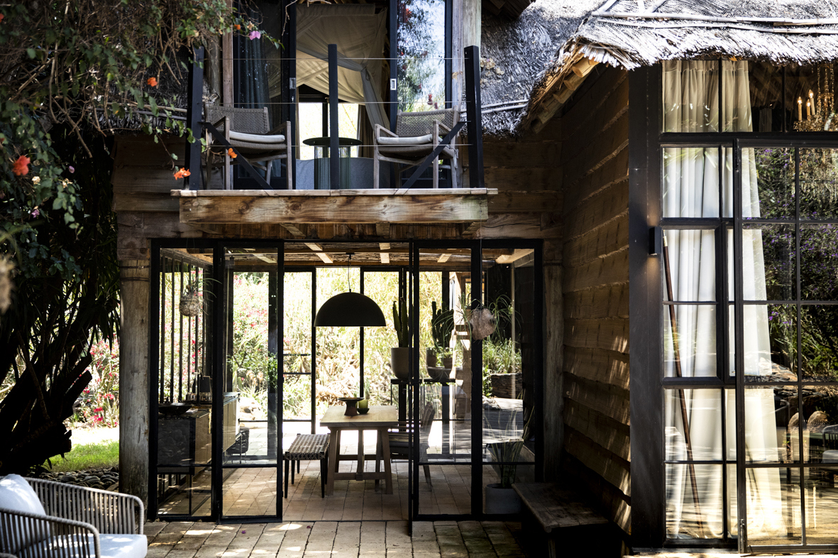 The detailed exterior of a wooden lodge with lots of windows