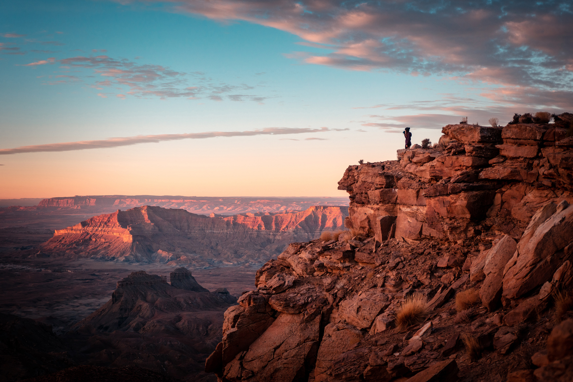A person stood on the top of a rocky mountain