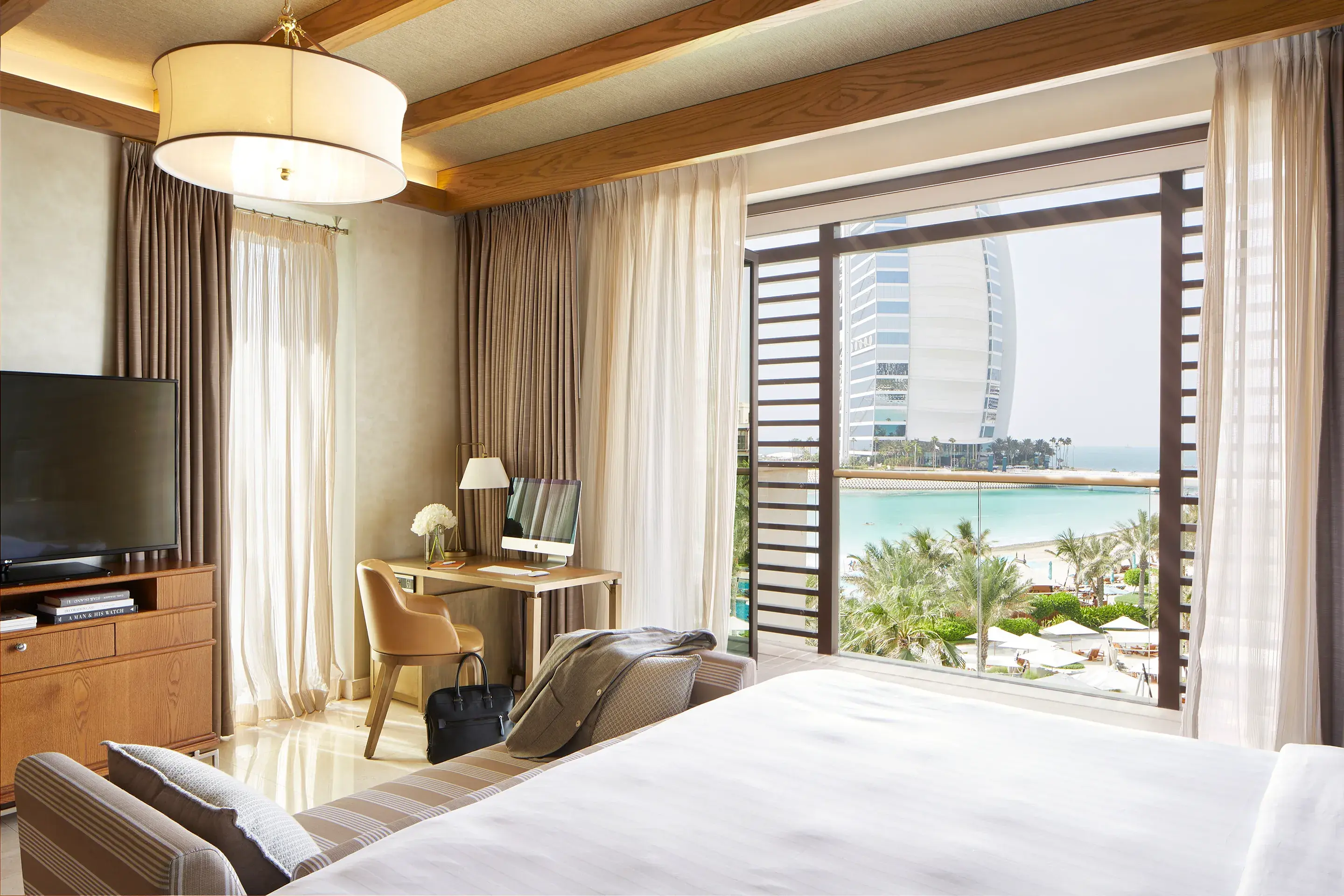 Luxury bedroom at Jumeirah Al Naseem Dubai with beach views and a direct outlook to the Burj Al Arab.