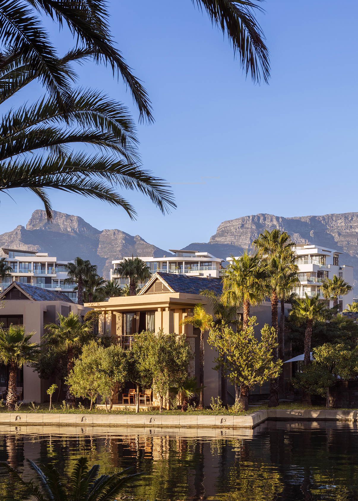 Africa, South Africa, One&Only Cape Town, villa exterior with balcony overlooking the water and table mountain in the background