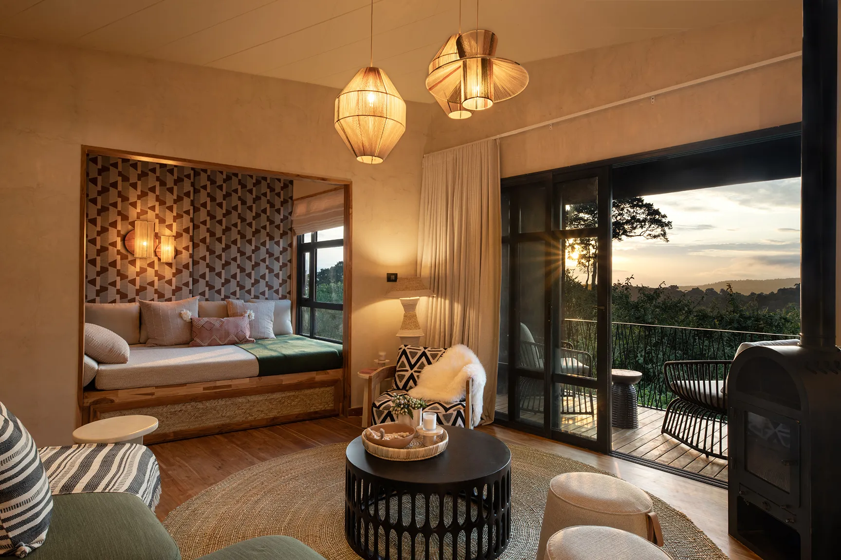 Luxury lodge suite with balcony seating and sunset forest views